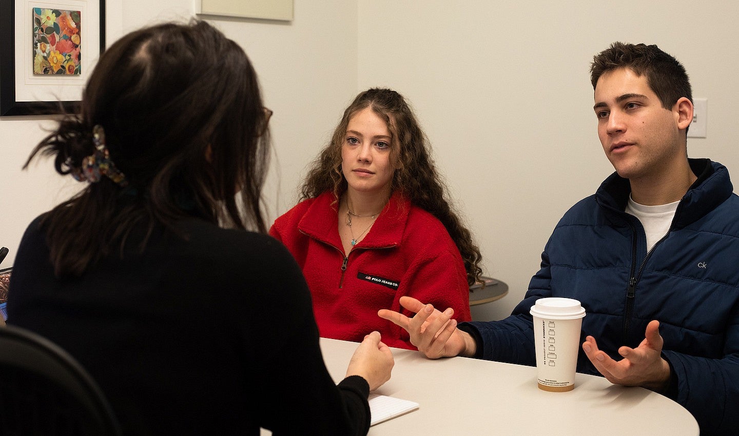two students in a meeting with an advisor