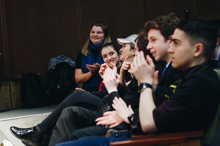 Students applauding at a Forensics Event.