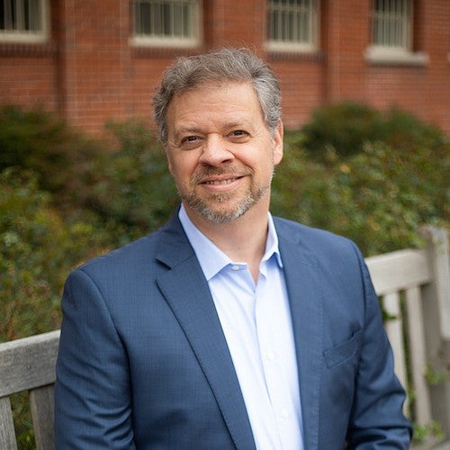 michael moffit portrait sitting on bench outside chapman hall