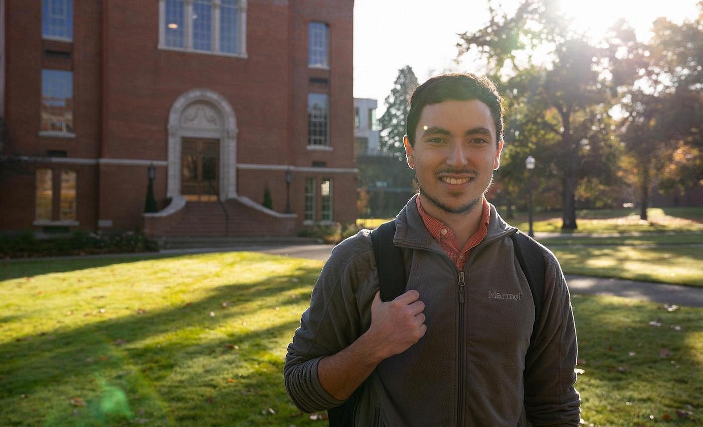 Smiling student standing in front of Chapman Hall.