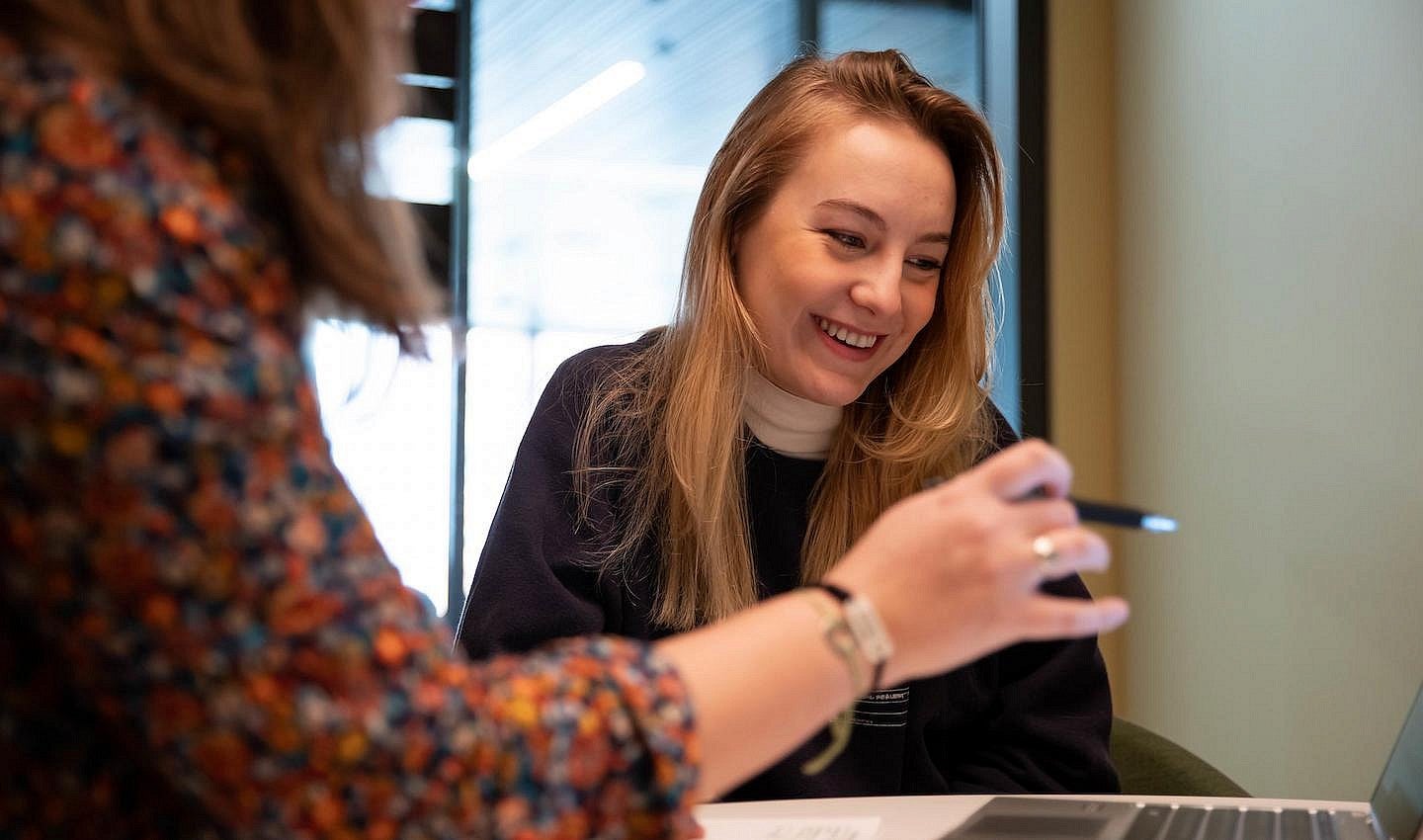 female student and advisor looking at a laptop together