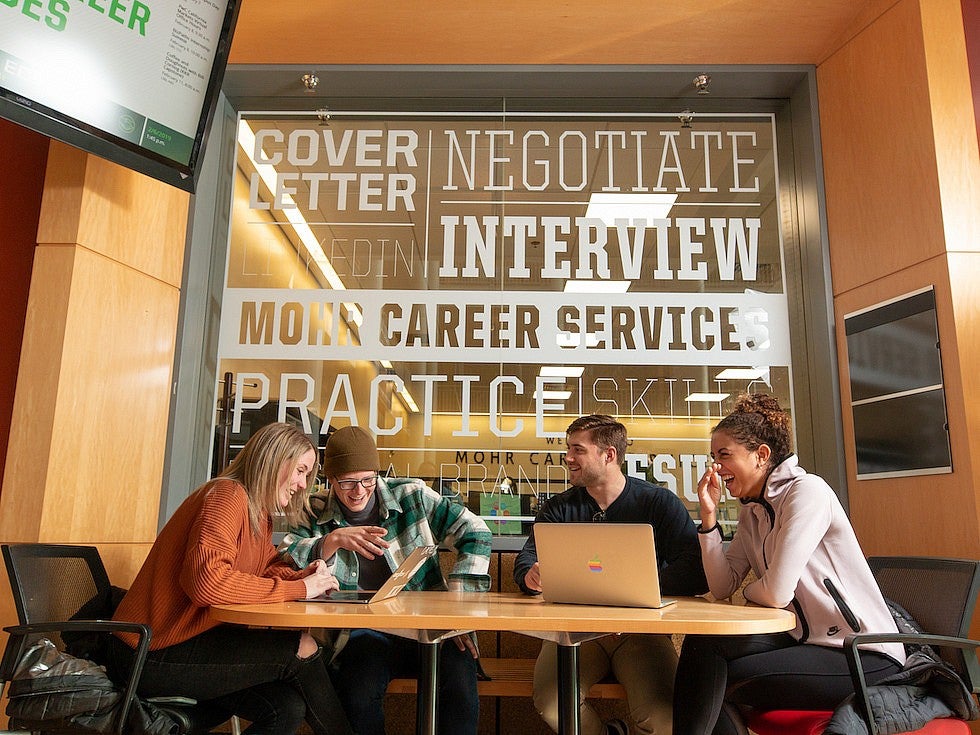 four students working around a table outside the Mohr Career Center