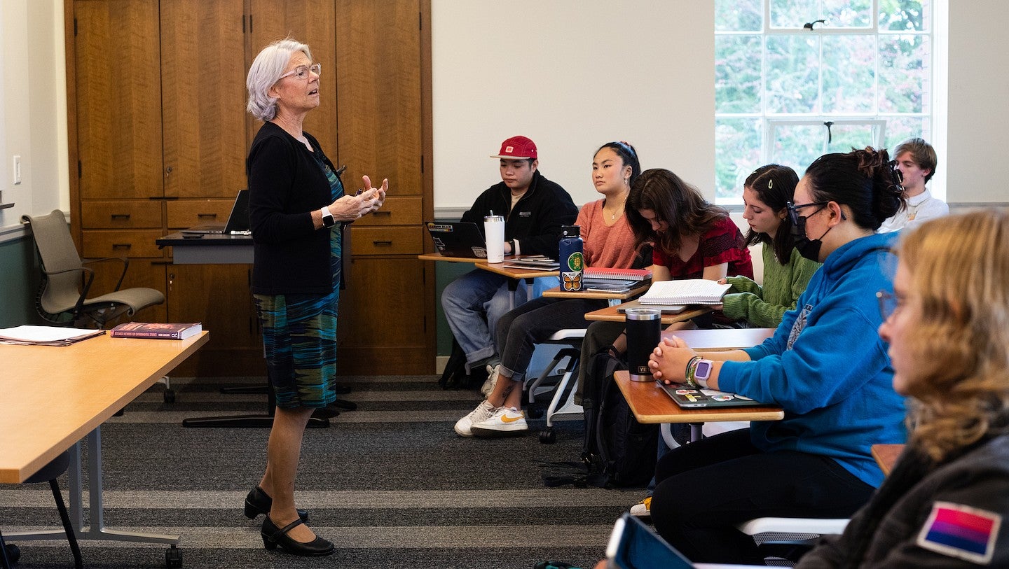 ellen fitzpatrick teaching at the front of a classroom