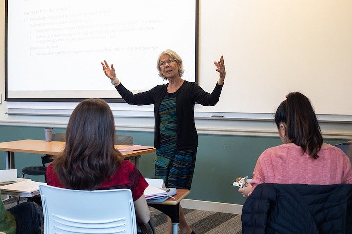 ellen fitzpatrick teaching at the front of a classroom