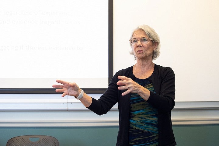 ellen fitzpatrick teaching at the front of a classroom