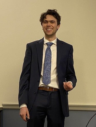 jakob hollenbeck posing in a suit