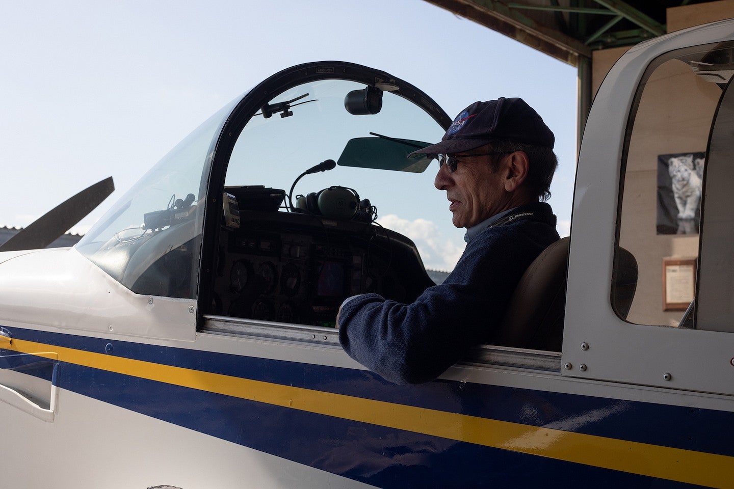 robert mauro in the cockpit of his small plane as he pulls out of the hangar