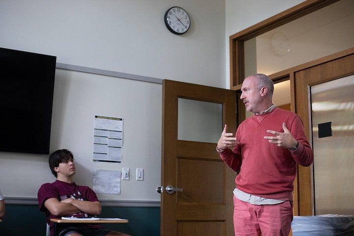 christopher michlig teaching a student in a classroom