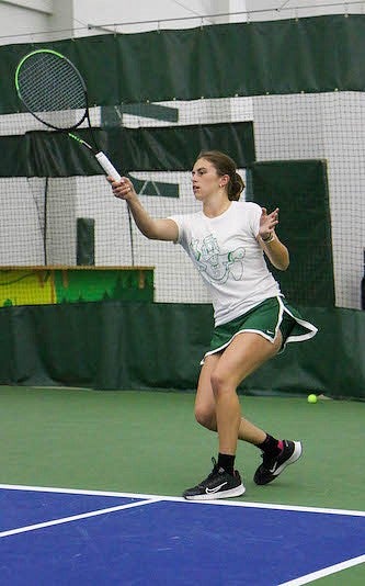 ruby wool playing tennis indoors
