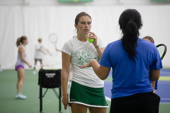 ruby wool in conversation with another player on the tennis court