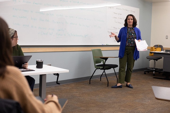 courtney thorsson gesturing while teaching in a classroom