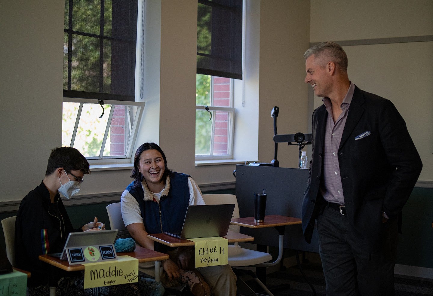 tobin hansen teaching in a classroom with students laughing at desks