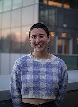 PORTRAIT OF STUDENT WAVERLY WILSON outside knight campus building at dusk