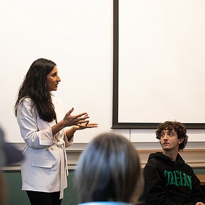 anita chari teaching at front of classroom, gesturing