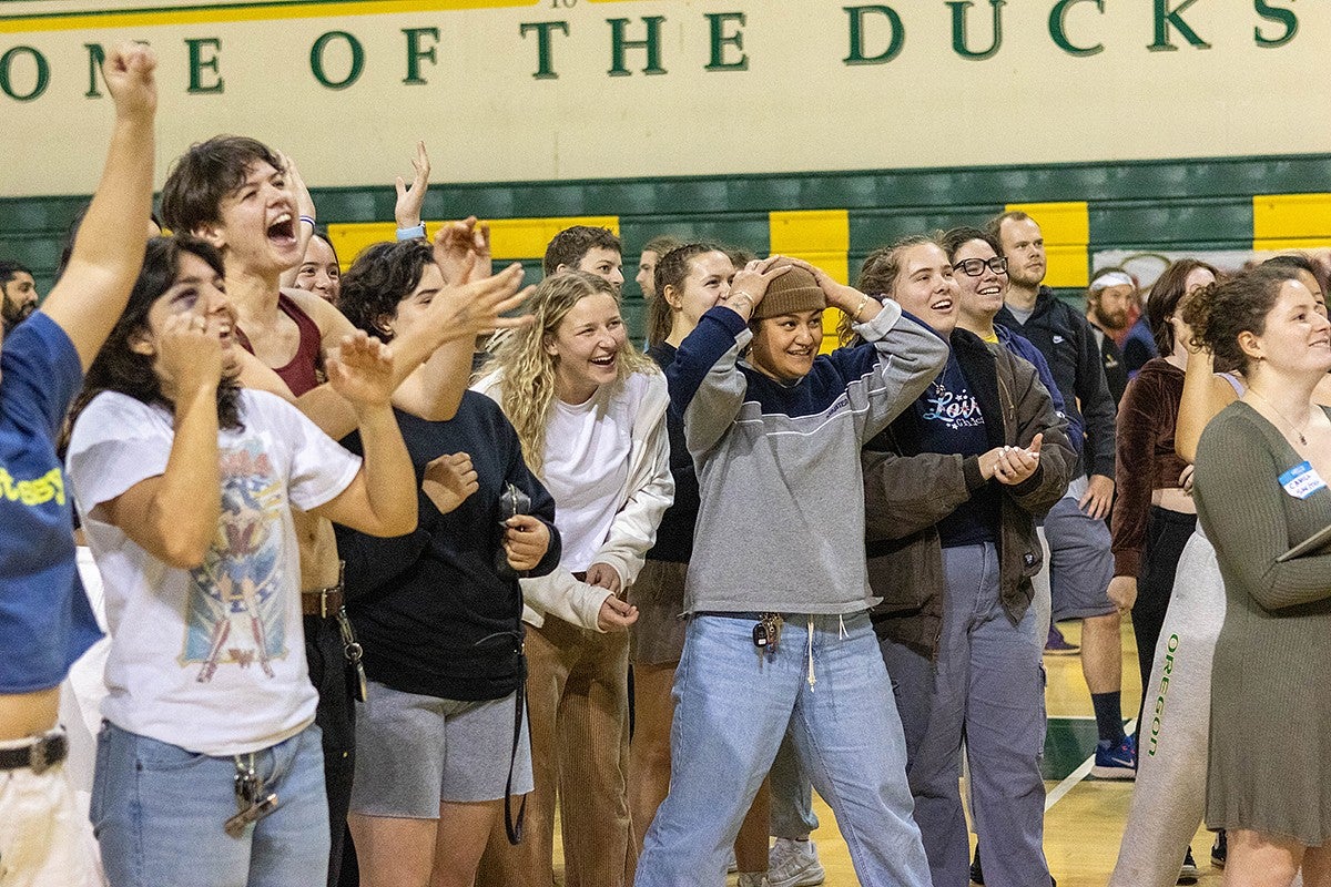 participants in a basketball hoop contest react to a basket