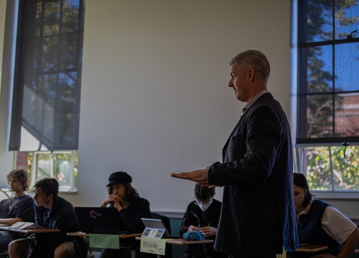 tobin hansen teaching in a classroom with students laughing at desks