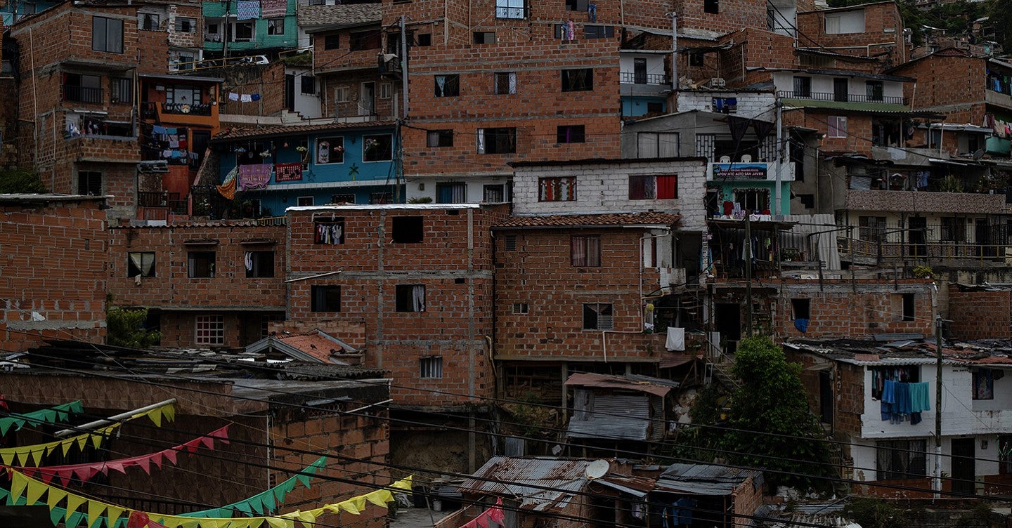 cityscape of a hillside covered with brick apartments built on top of one another