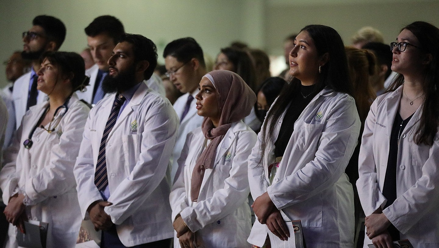 future doctors standing in a row at the OHSU medical school white coat ceremony