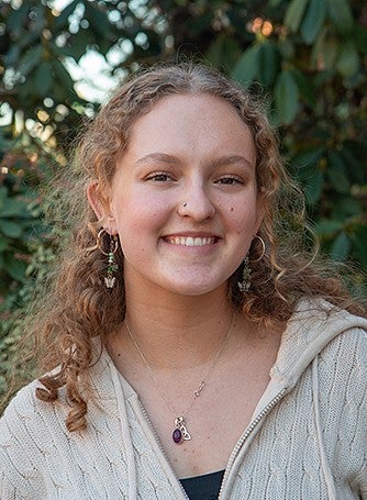 sierra hawes portrait with bushes in background