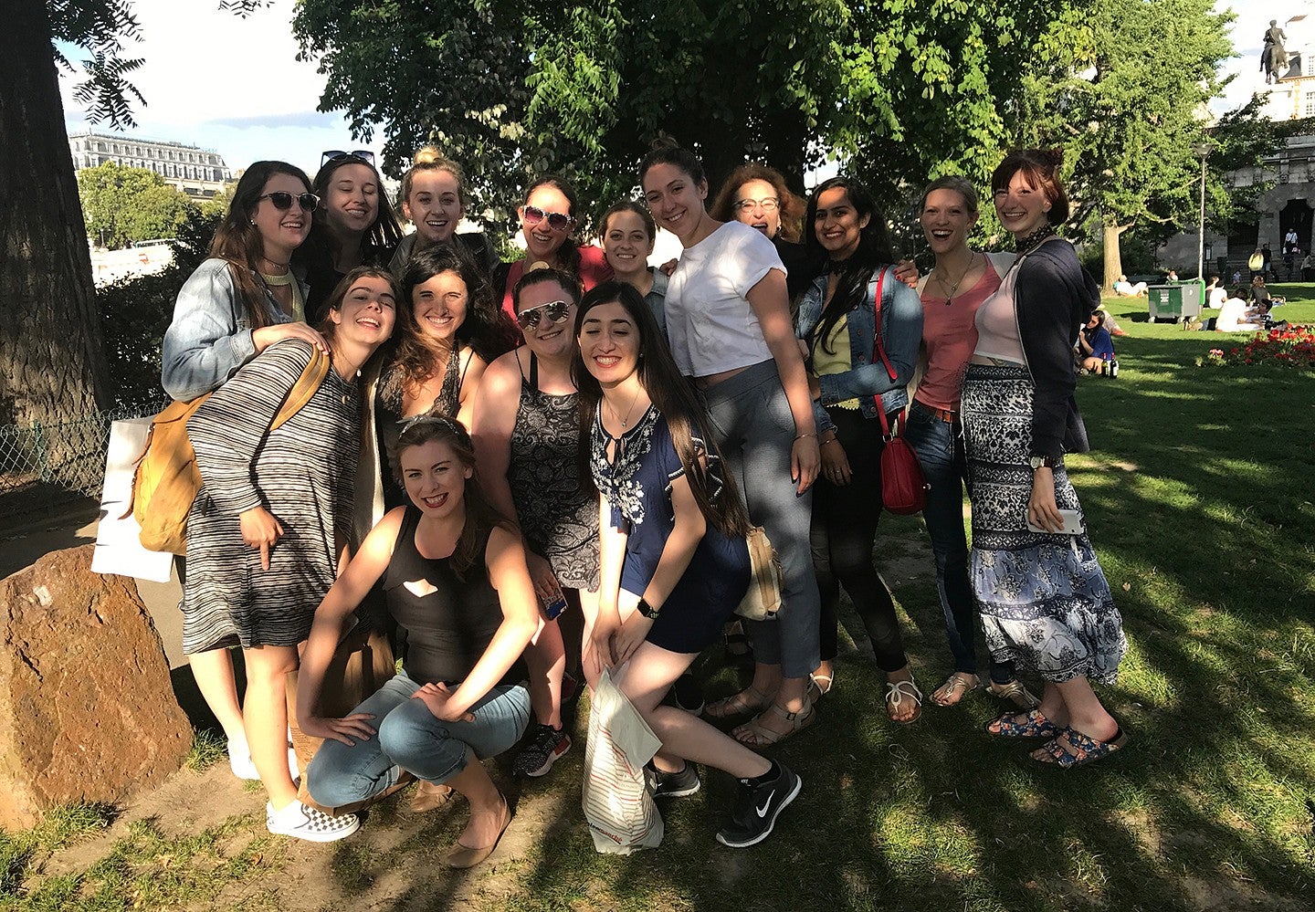 group of students posing in a park, smiling