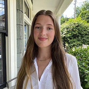 portrait of Hanna Minns on porch of a house