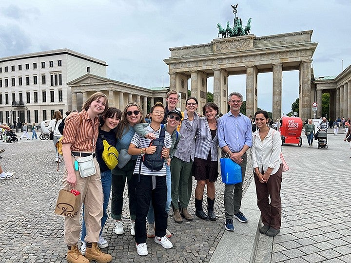 group of students posing in front of brandenburg gate