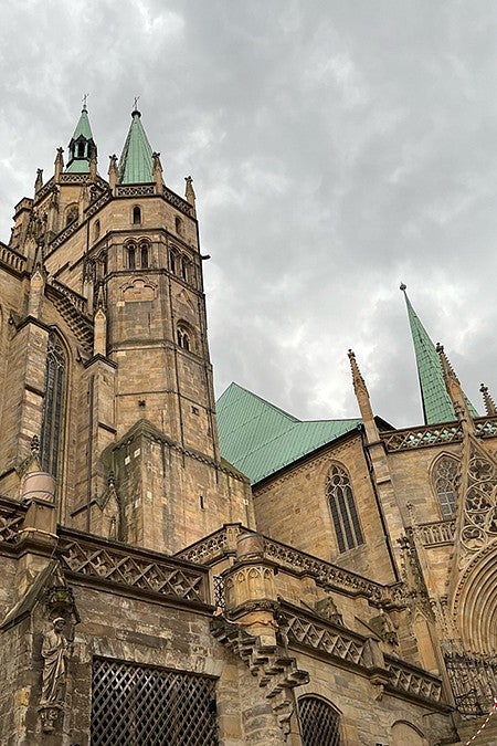 looking up at st mary's cathedral in erfurt with cloudy skies