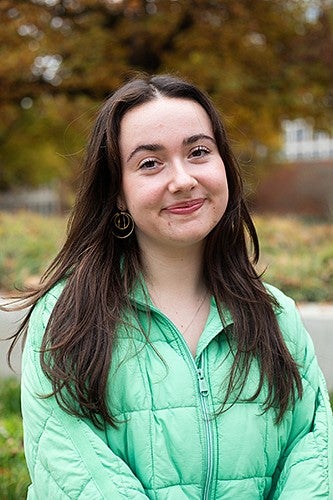 portrait of Maya McLeroy with fall foliage in background