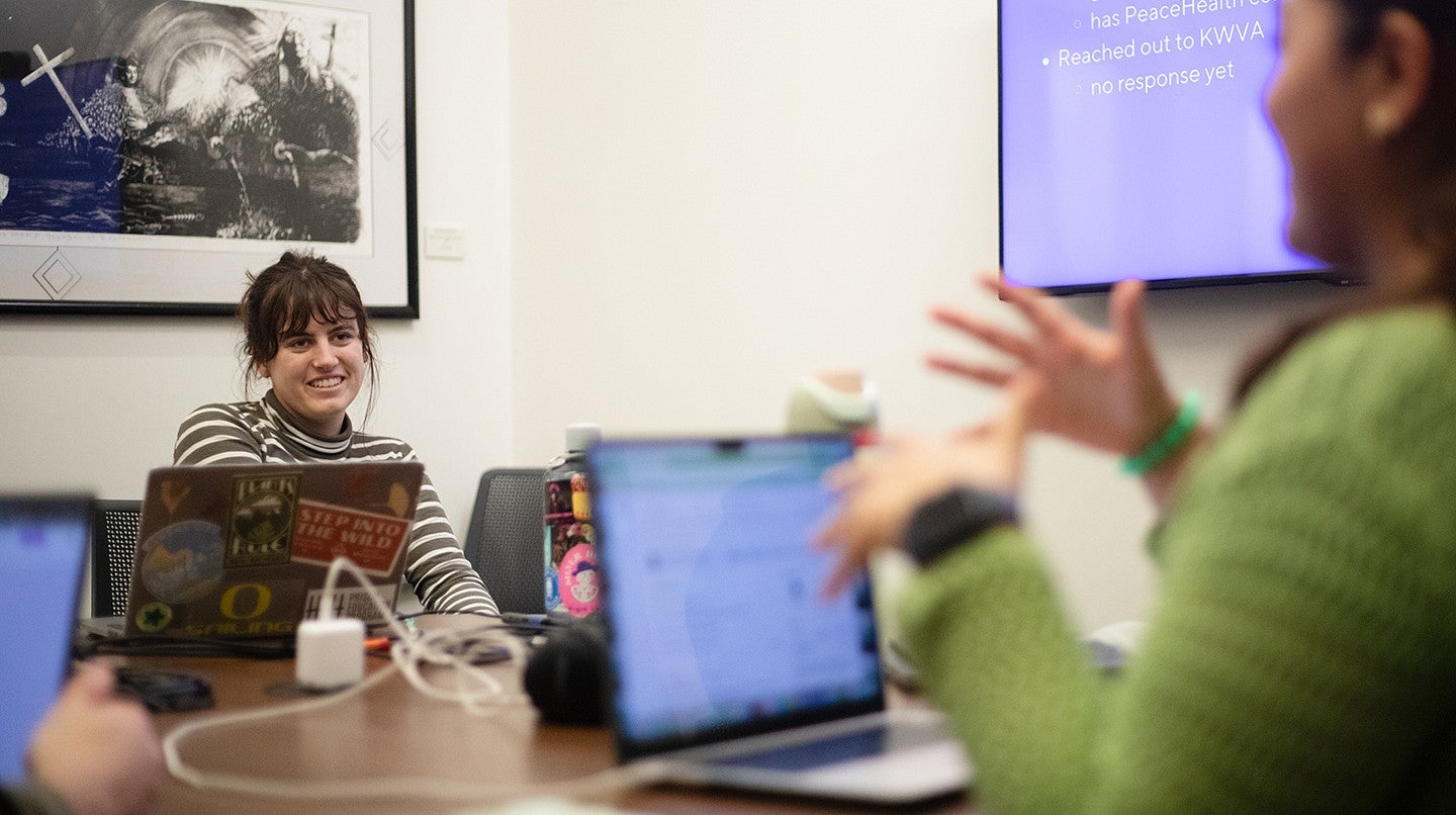 sadie creemer in a meeting with other students, seated around table with laptops