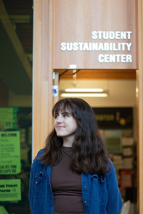 portrait of sadie creemer outside the entrance to the student sustainability center