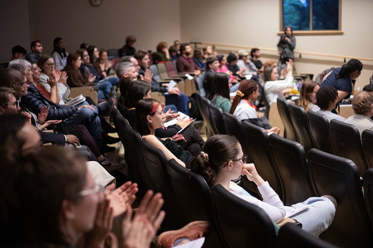 audience clapping at event in lecture hall
