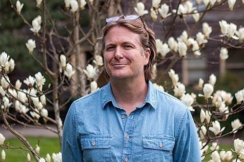 portrait of casey shoop in front of white magnolia blossoms