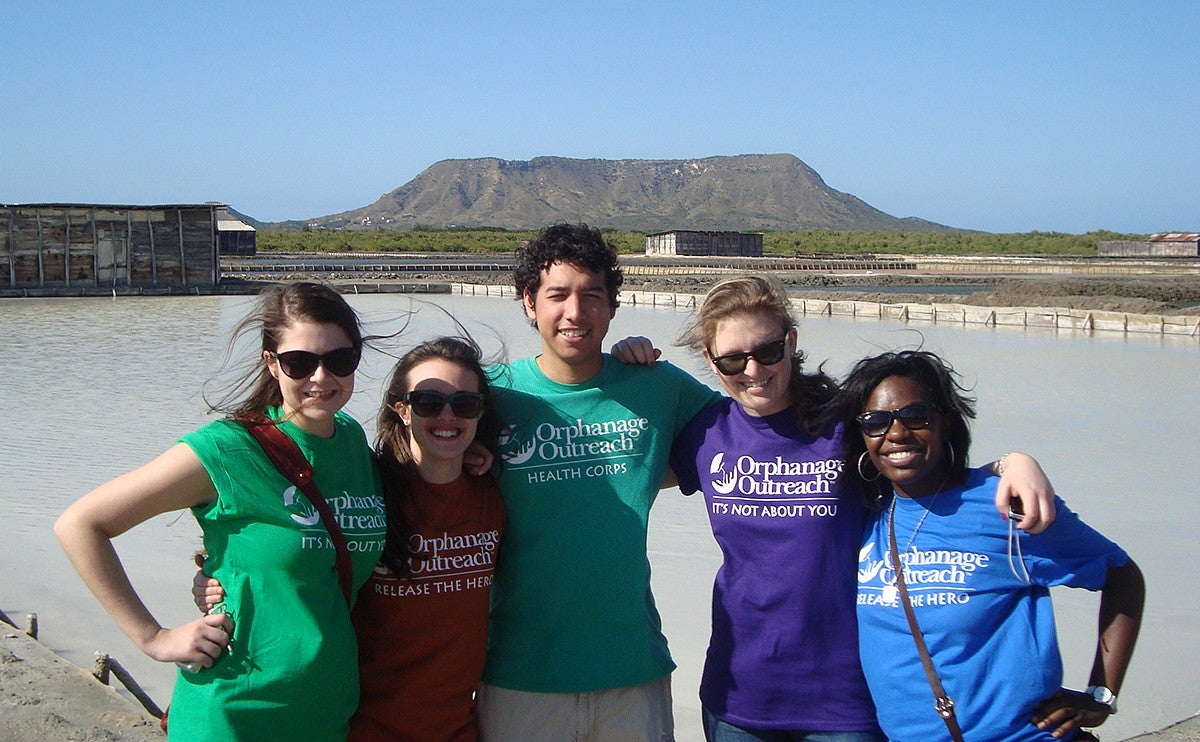 ann oluloro with classmates on a service trip to the dominican republic, posing in volunteer t-shirts