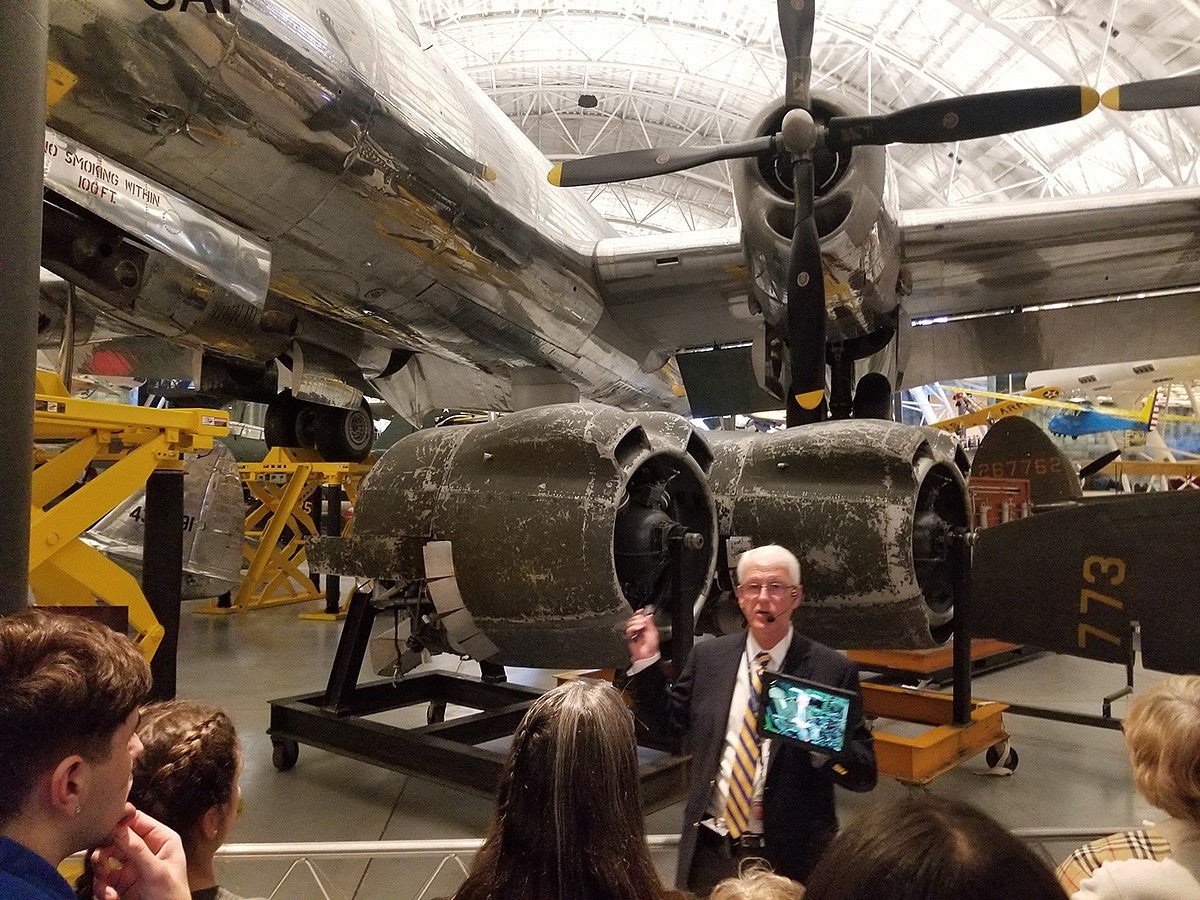 tour group viewing airplane in museum