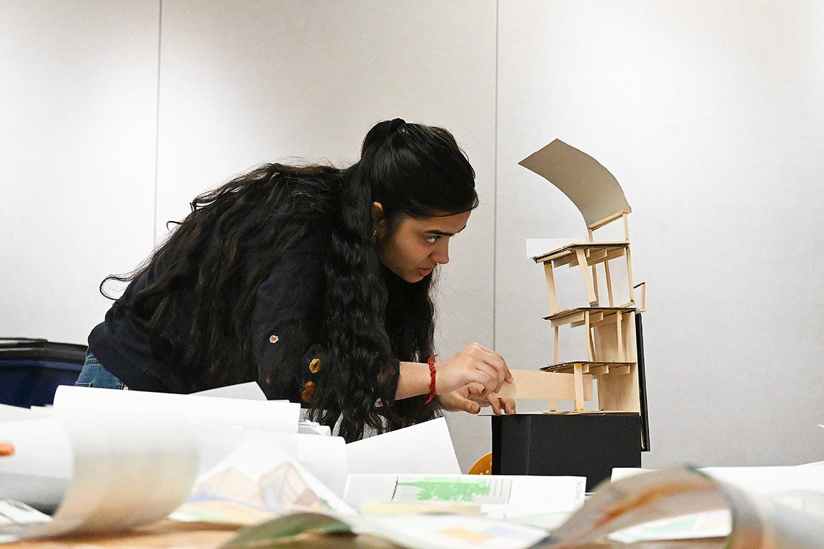 gayatri misra adjusting an architectural model in a design lab