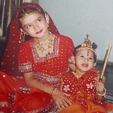 young gayatri misra in traditional indian holiday attire with baby brother