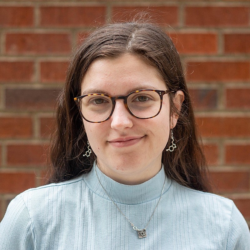 portrait of lawren paris in front of brick wall