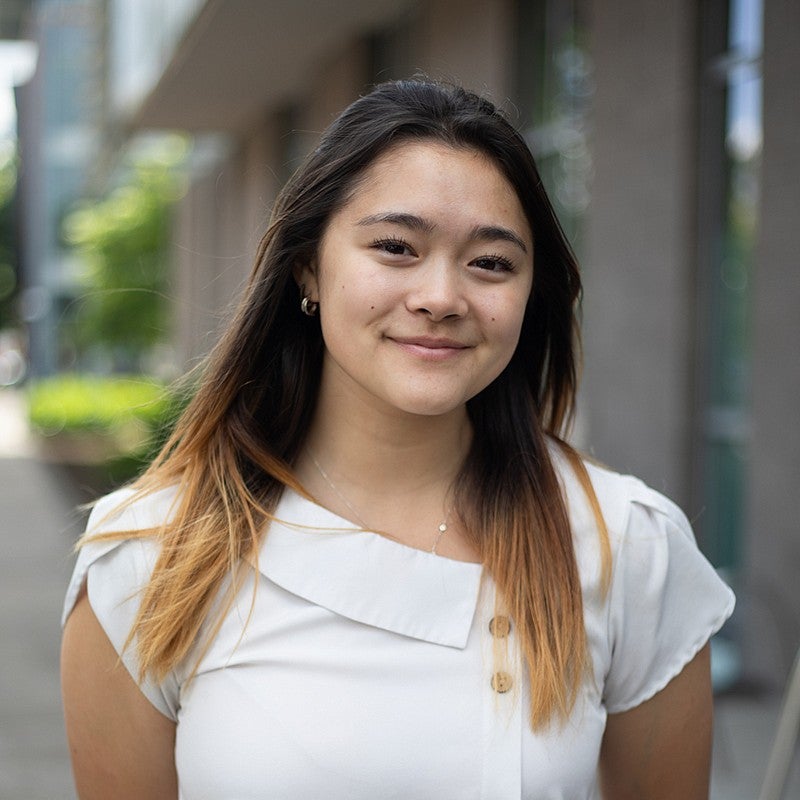 portrait of Maya Sayuri outside a UO campus building