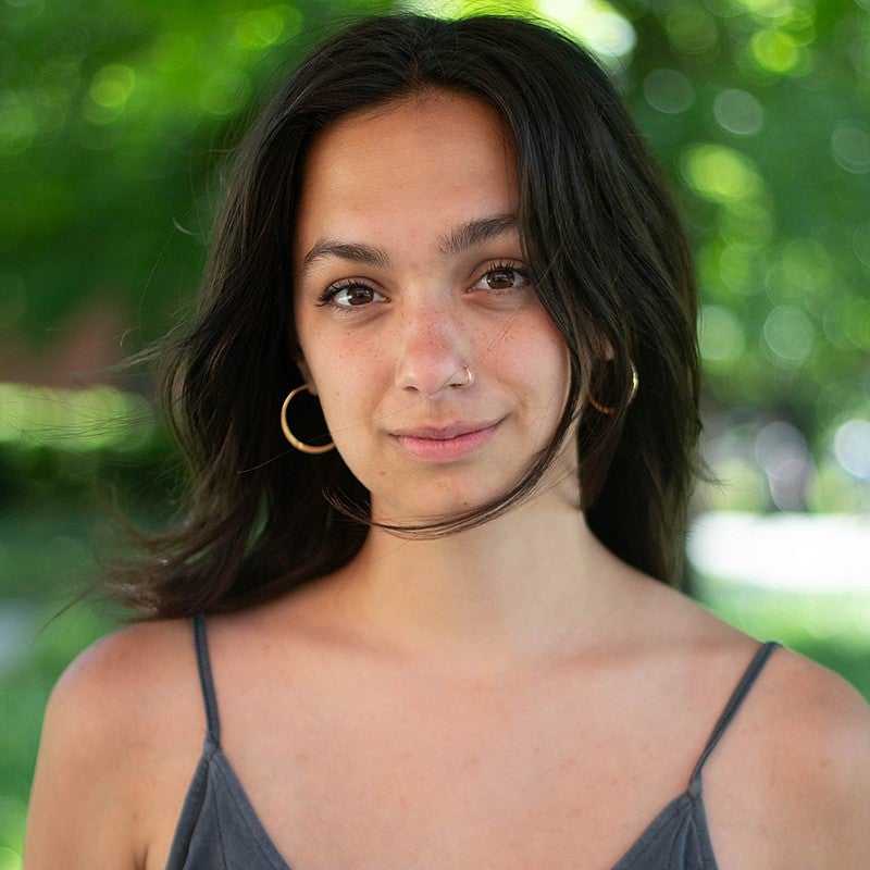 portrait of miriam yousaf with leafy background