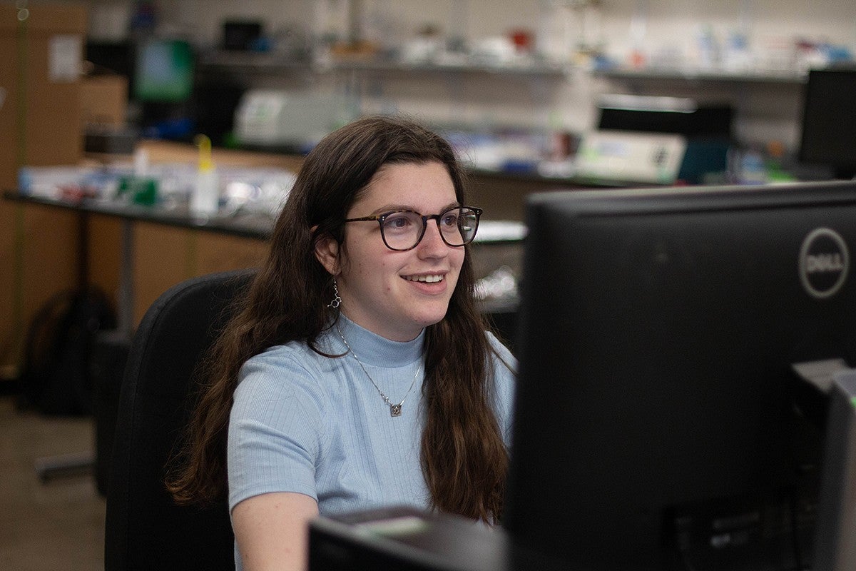 student in lab seated at computer