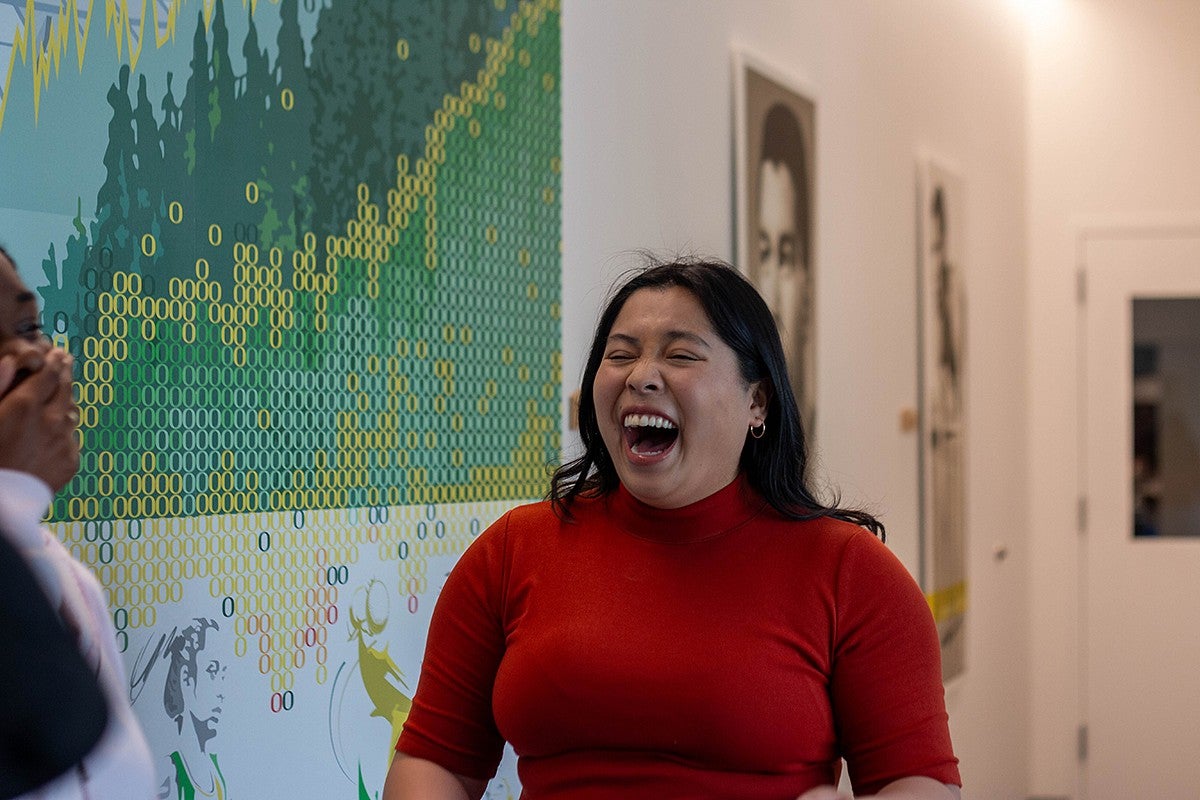 student laughing in campus building