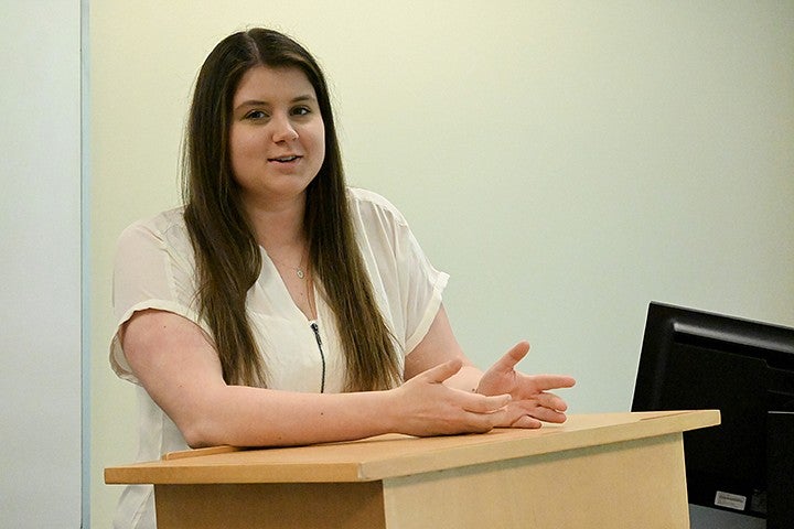 student speaking from podium in classroom