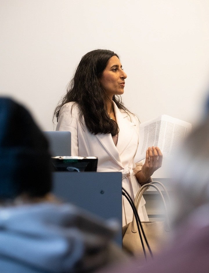 Anita Chari teaching at front of classroom