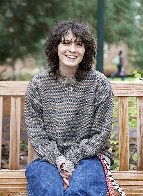 portrait of danna rubesh on outdoor campus bench