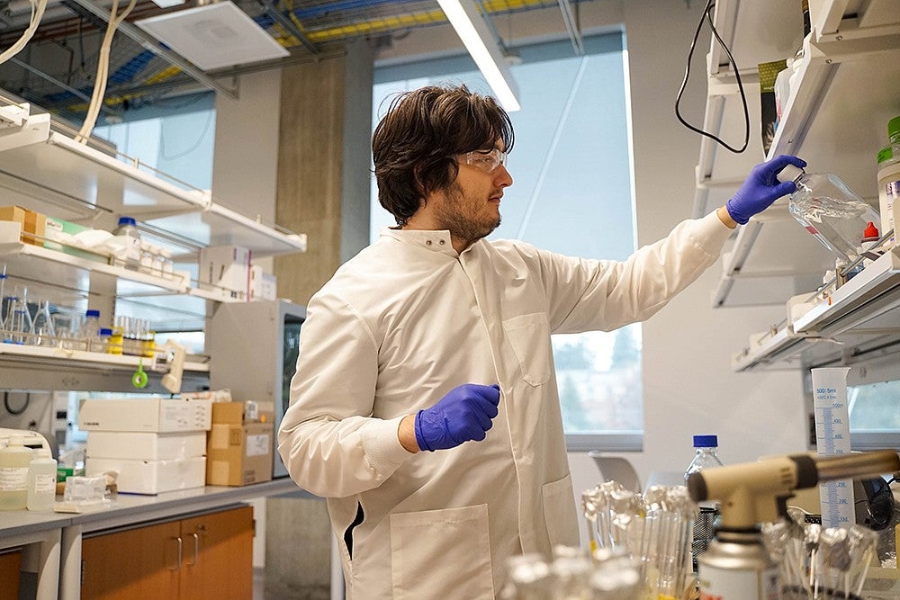 oliver loreto handling chemicals at a lab bench