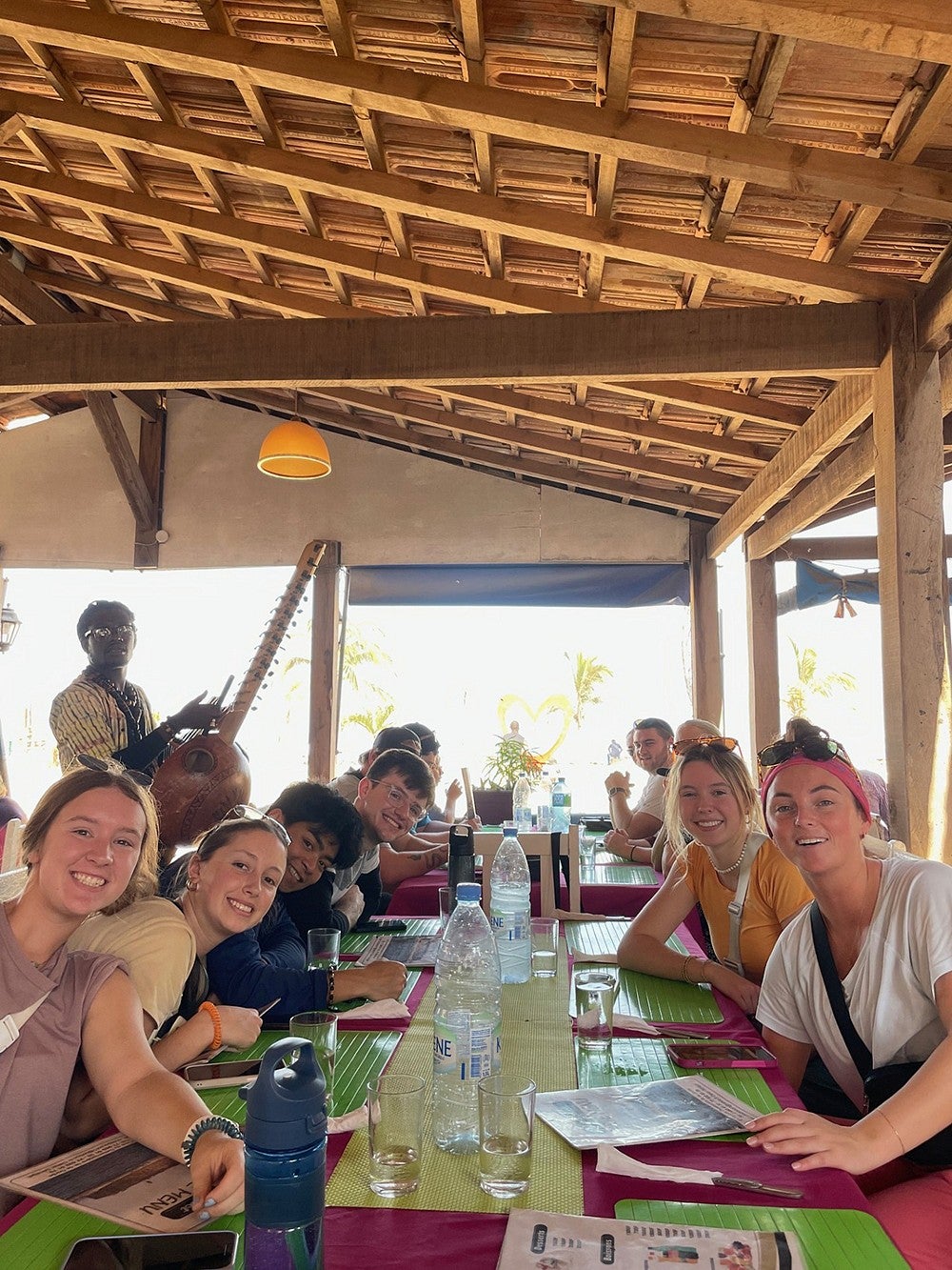 group of students around table in open-air restaurant