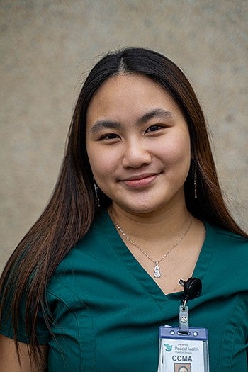 portrait of dora ho wearing medical scrubs