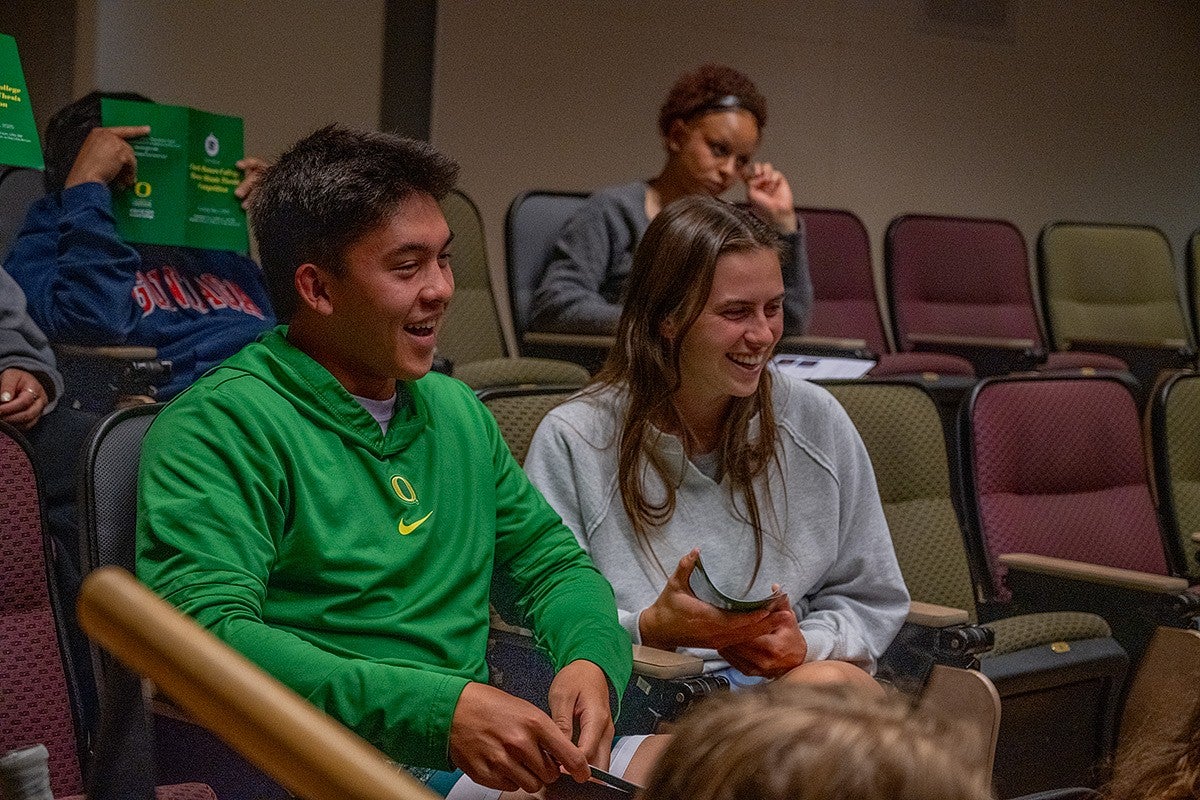 students in three minute thesis audience, smiling