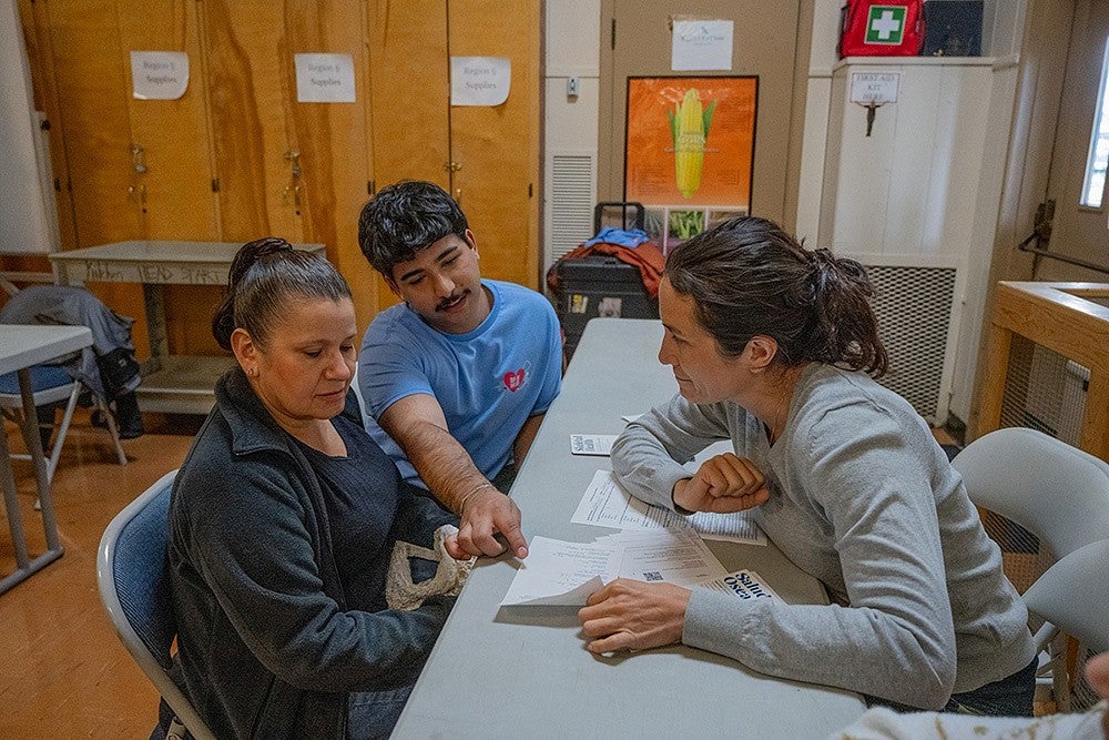 student volunteer working with patient in community clinic