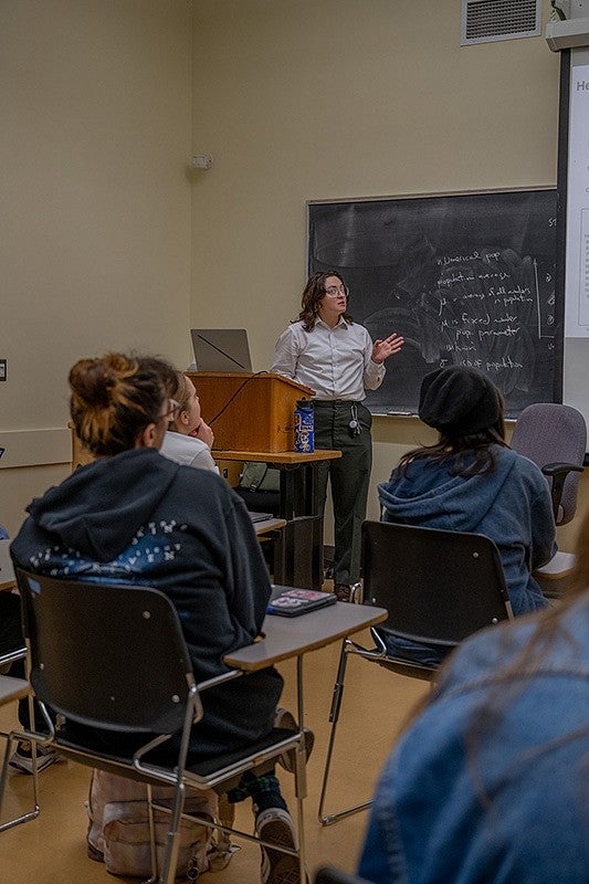 student presenting at front of classroom
